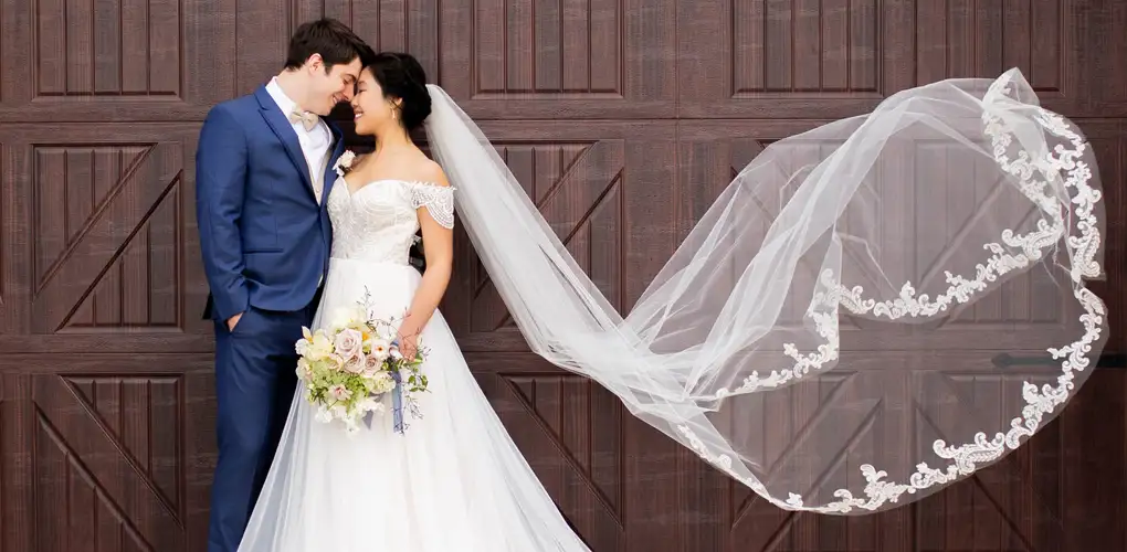 Newly married couple in front of a barn door.