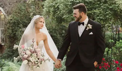 Groom wearing a big and tall style suit with his bride