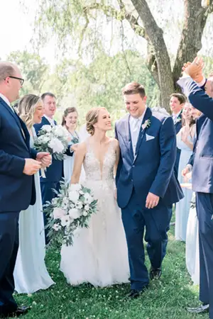 Groom walking with his bride while wearing a big and tall style