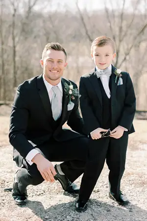 Groom and Ring Bearer in matching tuxedos.