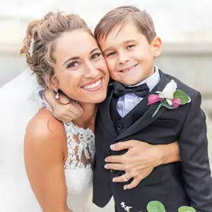Bride and ring bearer wearing a discounted tuxedo.