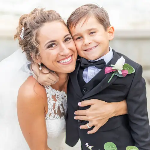 Bride and ring bearer wearing a discounted tuxedo.